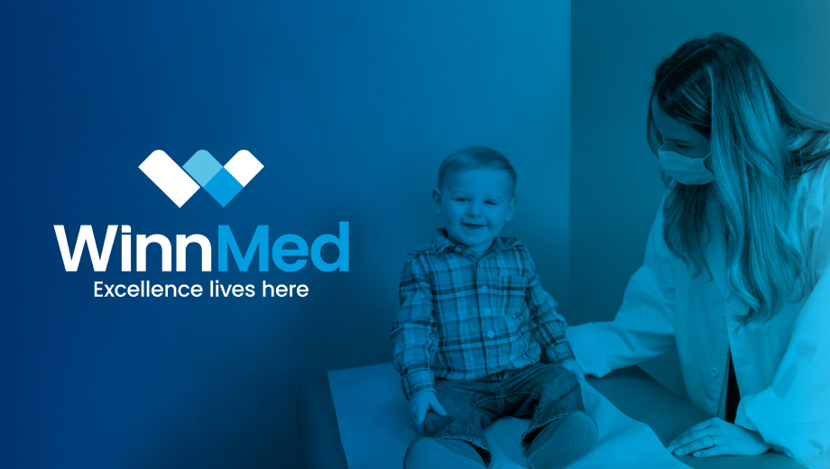 A blue-tinted photograph of a facemasked pediatrician interacting with a toddler. The Winnmed logo is on the left side with the tagline "Excellence lives here" below.